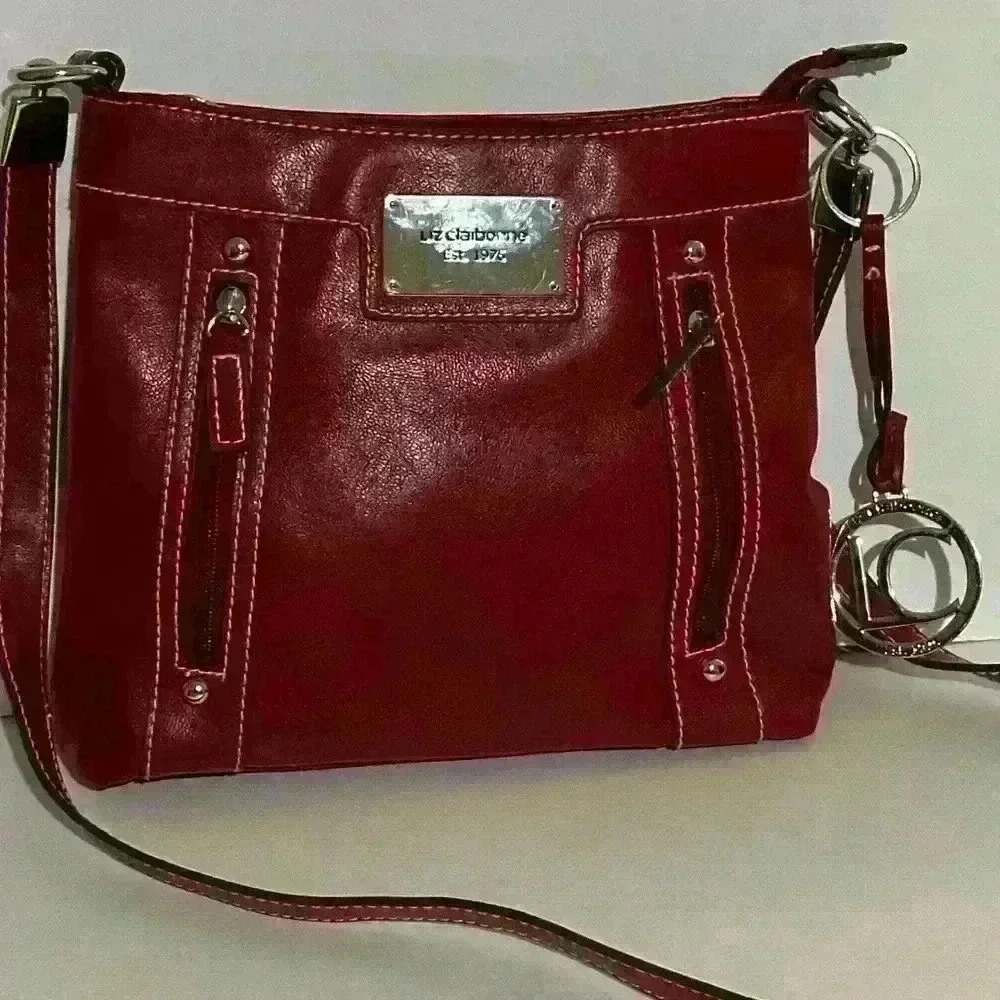 A burgundy / red Liz Claiborne crossbody bag.